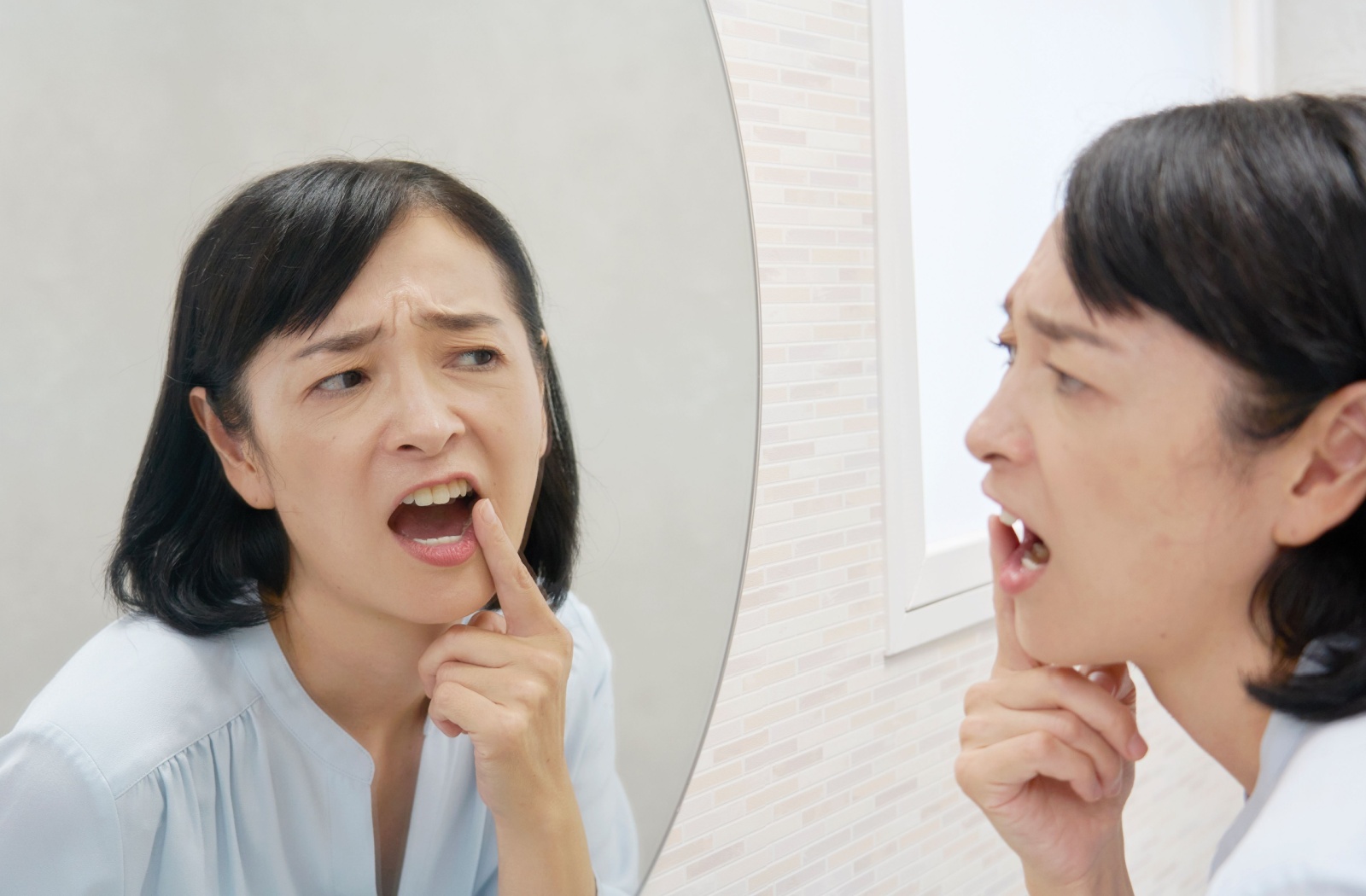 A person looking at a cavity in the mirror