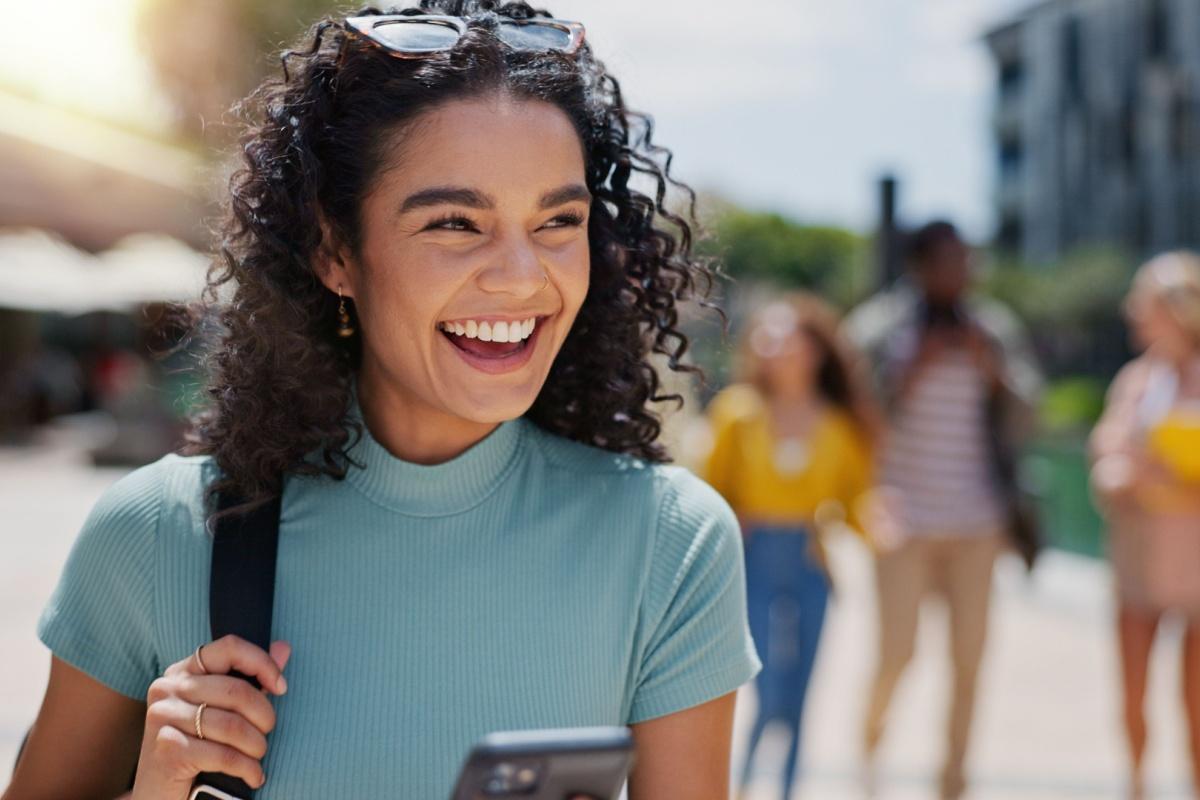 A person with perfect teeth smiling to show them off